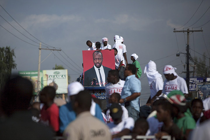 Wyclef campaigns: Residents hold image of Wyclef Jean in Port-au-Prince