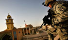 A US soldier on a rooftop in Samarra, the scene of heavy civilian casualties in October 2004