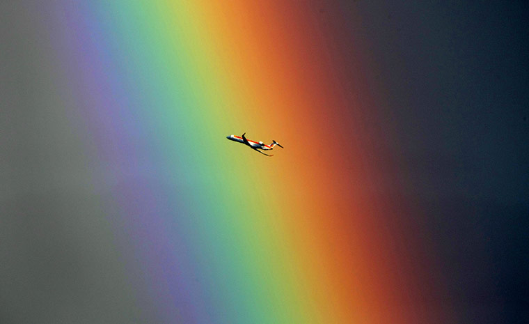 24 hours in pictures: A plane fly in front of a rainbow above the Mediterranean sea in Nice