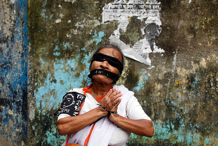 24 hours in pictures: A social activist participates in a rally in Mumbai
