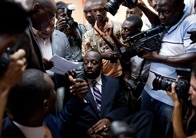 24 hours in pictures: Wyclef Jean surrounded by reporters runs for president of Haiti