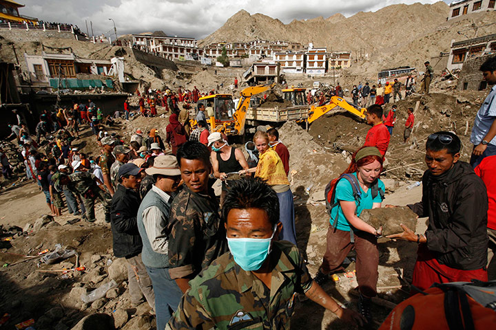 Leh flash floods: Foreign tourists assist locals in removing debris, Leh