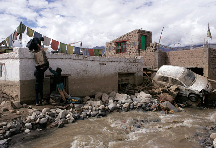 Leh flash floods: Flash flood victims retrieve their belongings from their damaged house, Leh