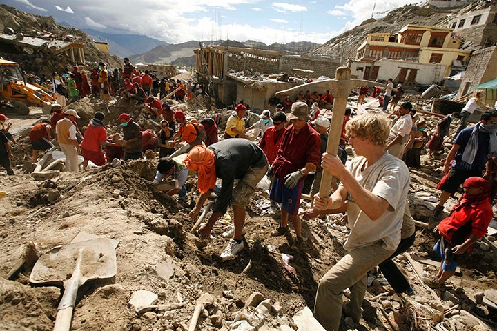 Leh flash floods: Foreign tourists assist locals in removing debris from flash flood area Leh