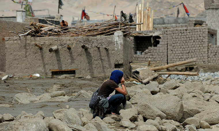 Leh flash floods: A woman ponders over the debris at Chuglamsar village in Leh