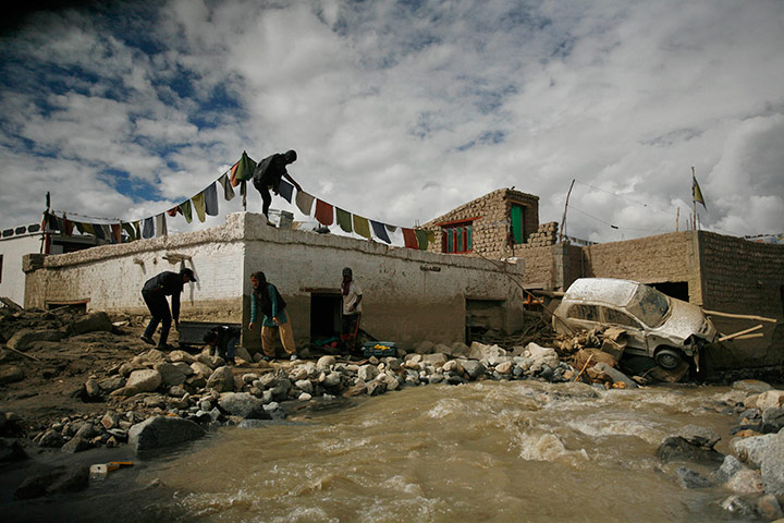 24 hours in pics: A family retrieves belongings from their flood damaged home, Choglamsar