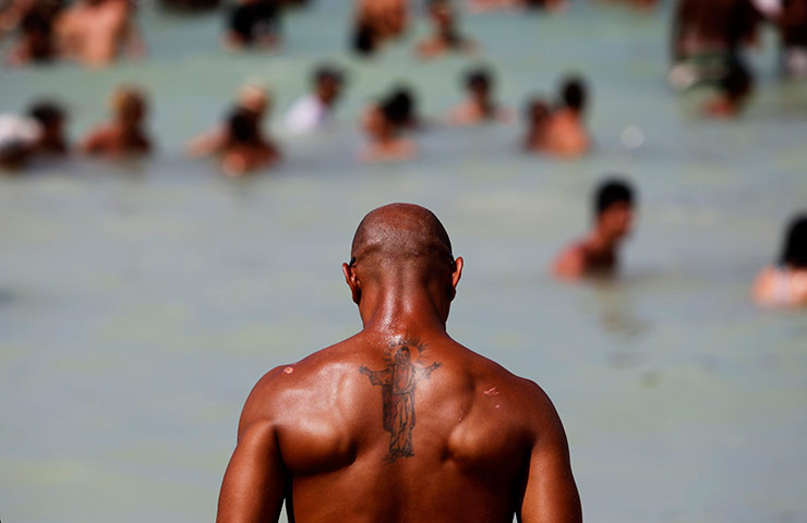 24 hours in pics: A man with a tattoo of Jesus Christ during the Rotilla Festival