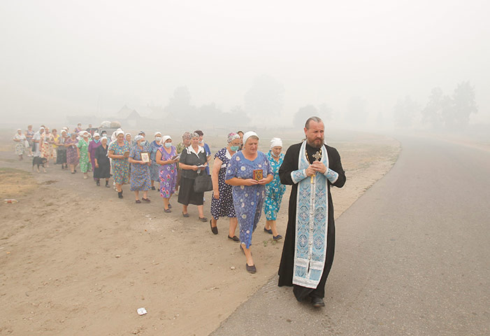 russia update: A priest and women take part in a religious procession, Kriusha
