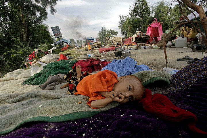 Pakistan update: A flood effected child seen at a roadside in Charsadda near Peshawar