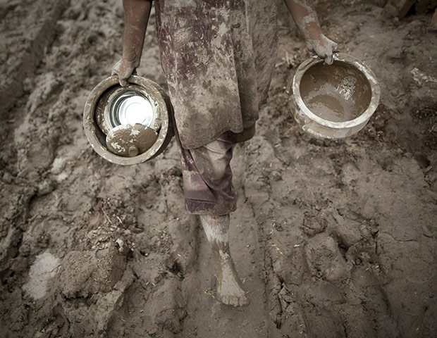 Pakistan update: A Pakistani man carries his belongings from his destroyed house