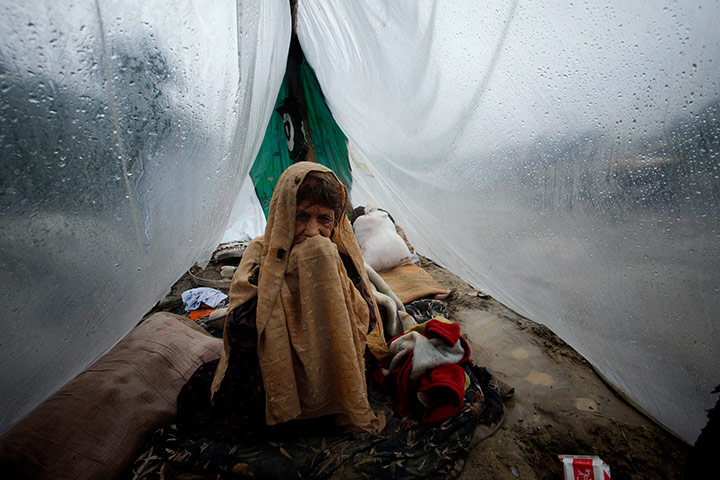 Pakistan update: A Pakistani flood effected woman sits inside her makeshift tent