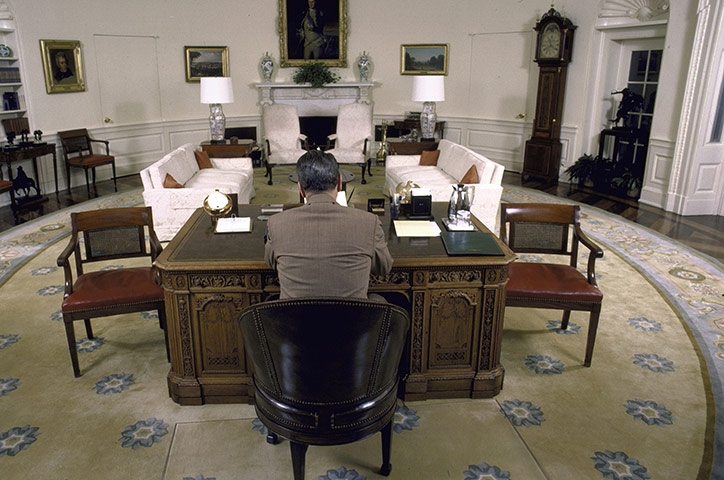 Oval Office redecoration: 1987: President Ronald Reagan sitting at his desk in the Oval Office 