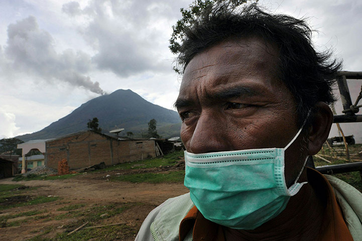 Mount Sinabung: A villager wears a protective face mask after Mount Sinabung erruption