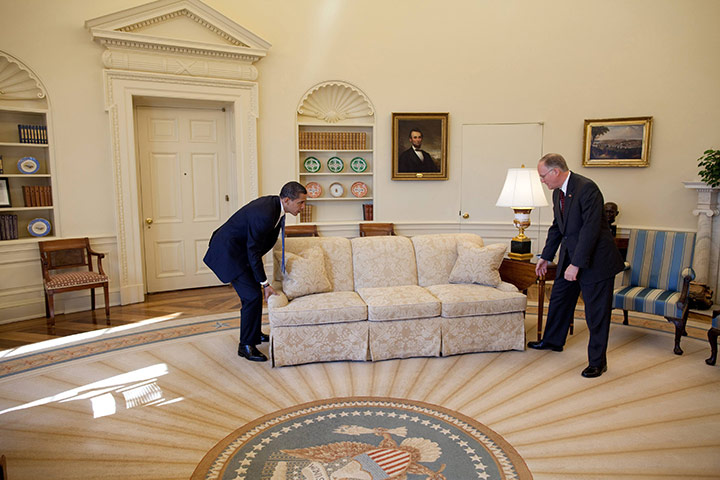 Oval Office redecoration: 2009: US President Barack Obama helps move a couch