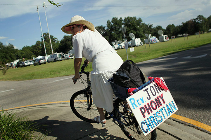 Qur'an Burning: Denise Gridley rides her bike in front of the Dove World Outreach Center