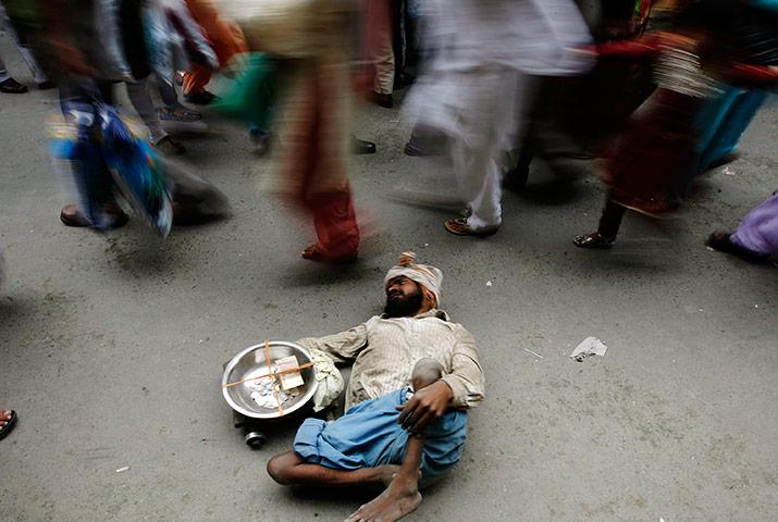 24 hours in pictures: A begger asks for alms in Srinagar