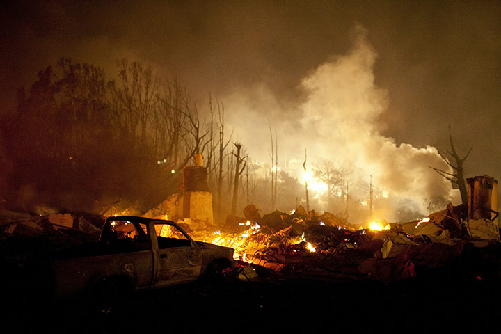 San Bruno fire: Smoke rises near chimneys remaining after a massive fire