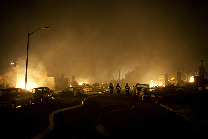 San Bruno fire: Firefighters walk down the street through the smoke during a massive fire 