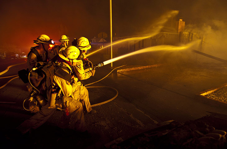 San Bruno fire: Firefighters protect a house after a massive explosion in San Bruno