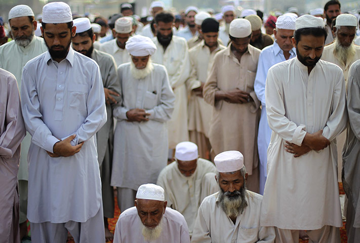 Eid festival: Villagers and flood victims pray near a relief camp in Nowshera, Pakistan