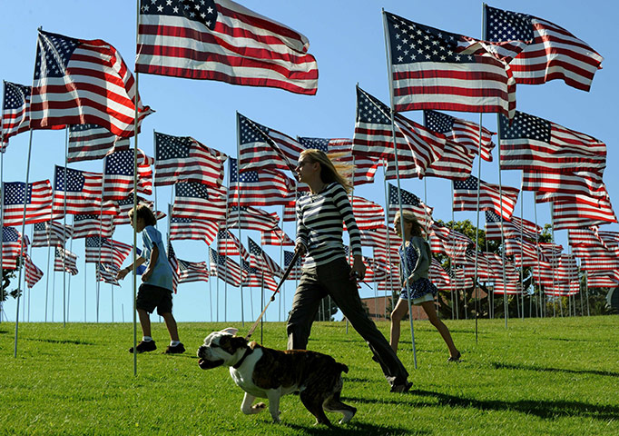 World Trade: People walk amongst flags honouring the victims of the terrorist attacks