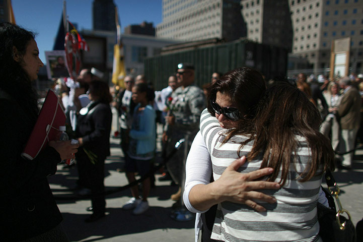 9/11 update: Family members of 9/11 victims gather on the edge of a reflecting pool