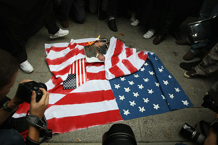 24 hours in pictures: Muslim protesters burn an American flag in London