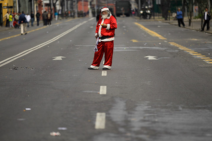 24 hours in pictures: A man dressed as Santa Claus after a demonstration in Chile