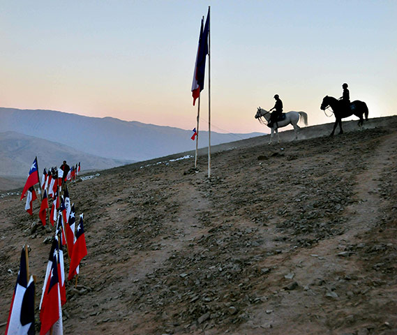 Trapped miners in Chile: 7 September: Two members of the mounted police watch the rescue area