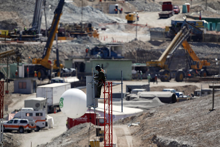 Trapped miners in Chile: 11 September: A man works on a top of a communication antenna 