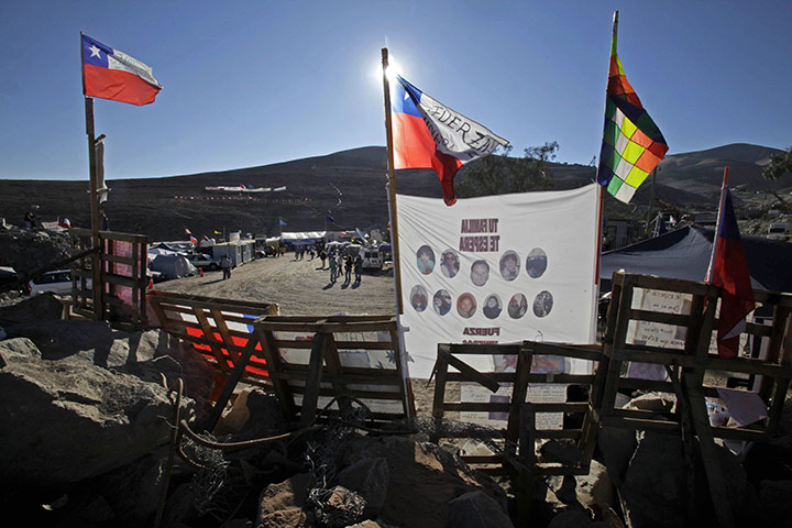 Trapped miners in Chile: 10 September: Images of trapped miners and Chilean flags sit at the camp