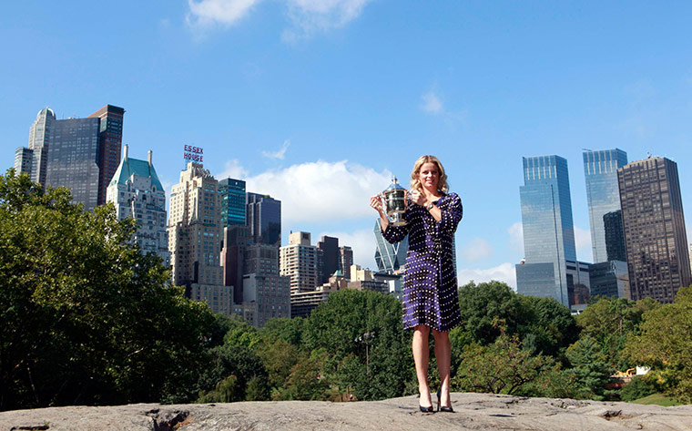 24 hours in sport: Kim Clijsters of Belgium poses with the women's U.S. Open tennis trophy
