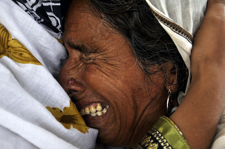 Six weeks later: Pakistan: Razia, a flood victim whose husband died this week is comforted 