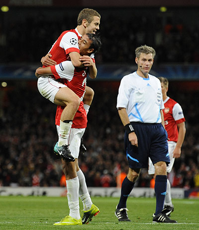 Arsenal v SC Braga: Arsenal's Chamakh lifts up team-mate Wiltshire after the 3rd goal