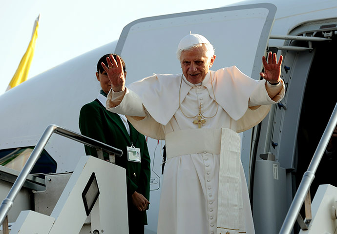 Pope arrives in Scotland: Pope Benedict XVI waves upon boarding a plane on his way to Scotland 
