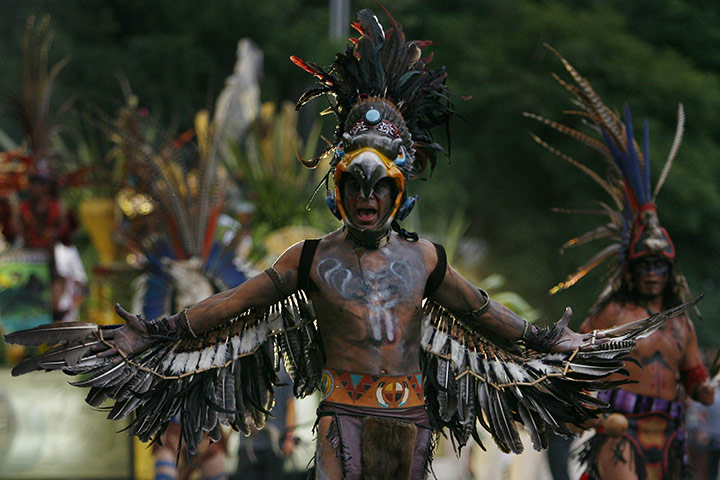 24 hours: Mexico City, Mexico: Men wearing Aztec costumes in the bicentennial parade
