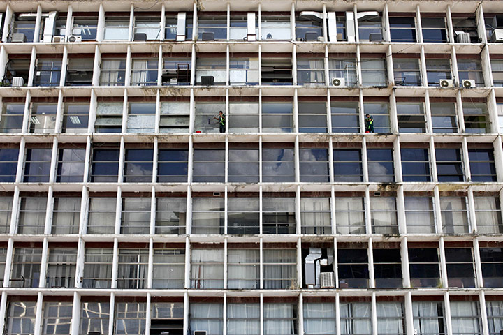 24 hours: Caracas, Venezuela: Caracas municipality workers clean the windows