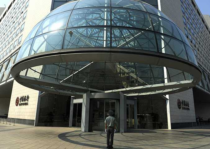 Week in Business: A security guard stands on duty at the Bank of China building in Beijing