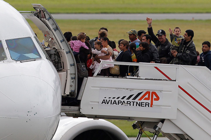 Roma Return : Roma families wave before boarding a flight to Romania 
