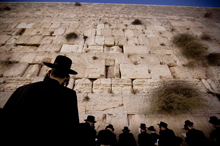 Yom Kippur: An Orthodox Jewish worshipper prays at the Western Wall before Yom Kippur