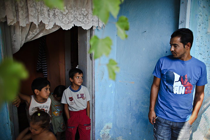 Roma in Romania: Romica Raducanu glances at his children outside his house 