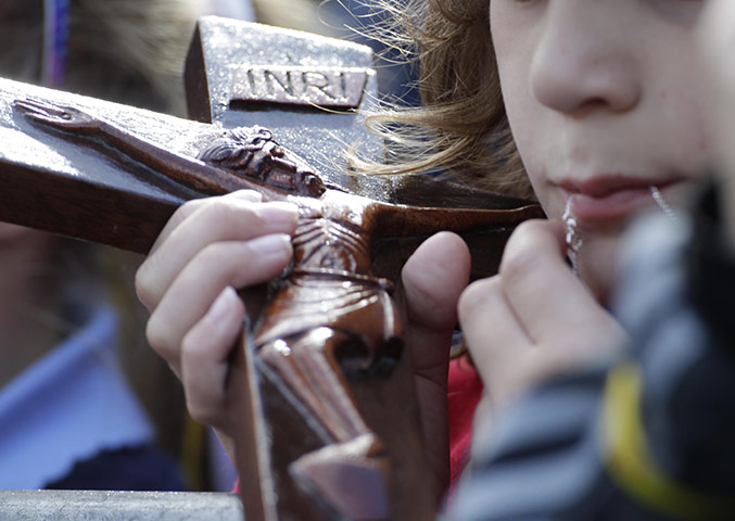 Pope 3: A child  holds crucifix during Pope Benedict XVI visit