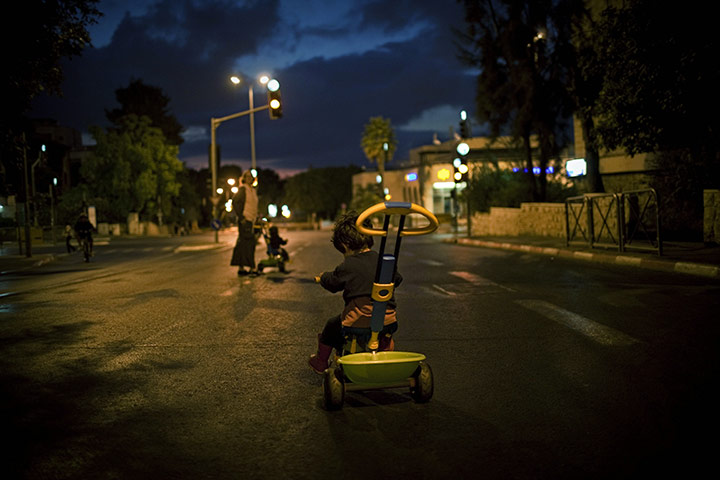 24 Hours in Pictures: An Israeli child rides in an empty street in Jerusalem during Yom Kippur 