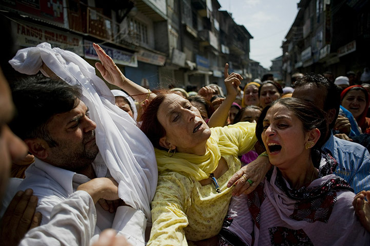 24 Hours in Pictures: Kashmiri relatives of Sheikh Yasir mourn at his funeral