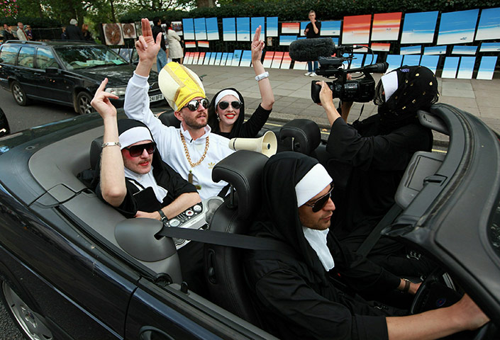 Pope Day 2: Anti-Pope protestors drive in an open top car near Hyde Park