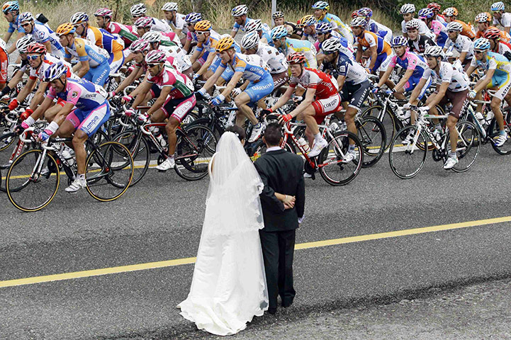 24 hours in pictures: A newly married couple watch riders during the Tour of Spain