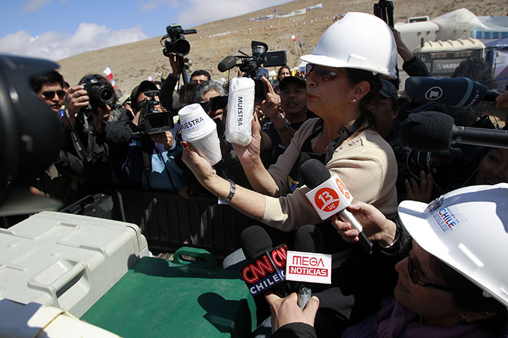 Chile Miners Update: A woman holds up packed examples of food meant for the miners