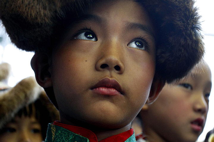 Tibetan Democracy Day: An exiled Tibetan boy waits to perform a traditional dance