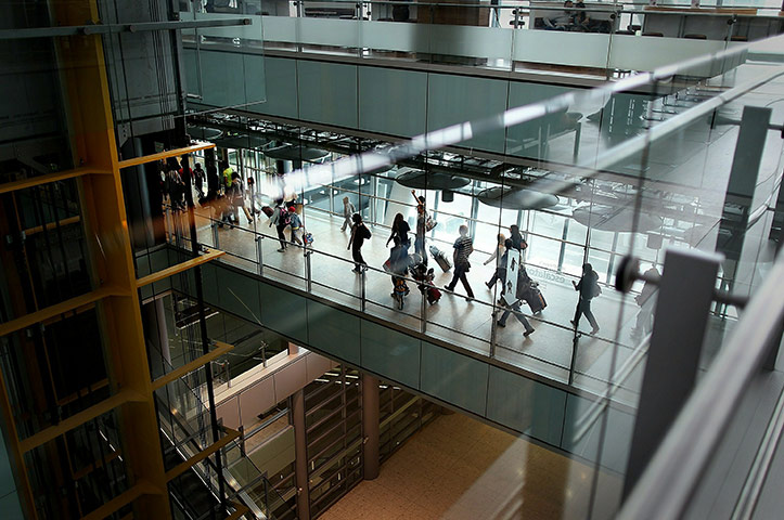 Week in business: Passengers walk to passport control at terminal five at Heathrow airport