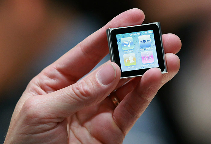 Week in business: An Apple employee holds a new iPod Nano at an Apple Special Event